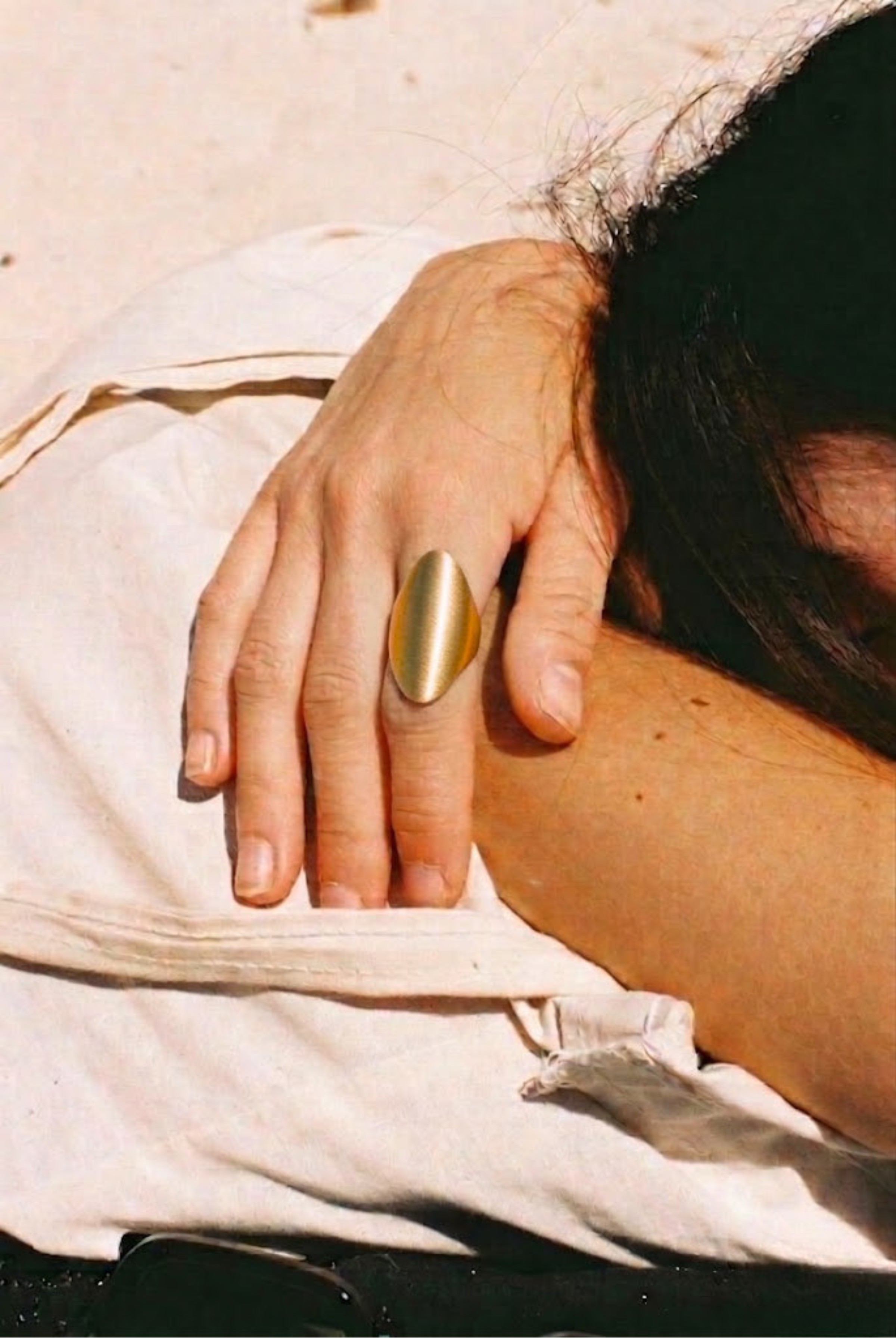 A model wearing a chunky gold statement ring