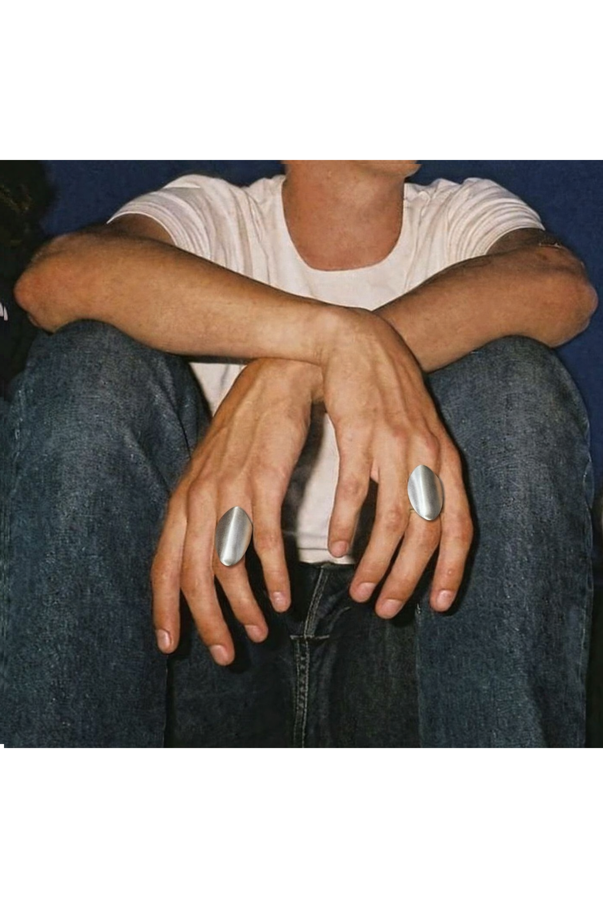 A chunky silver statement ring worn on the hand