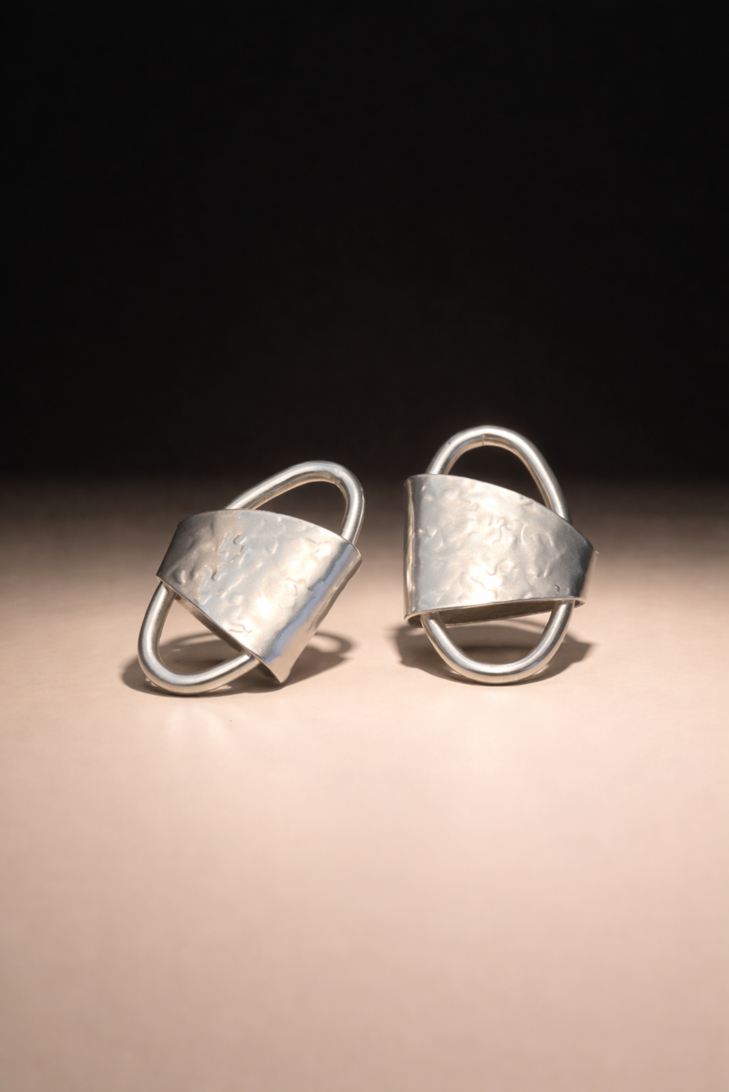 Bold gold geometric stud earrings shown on their own