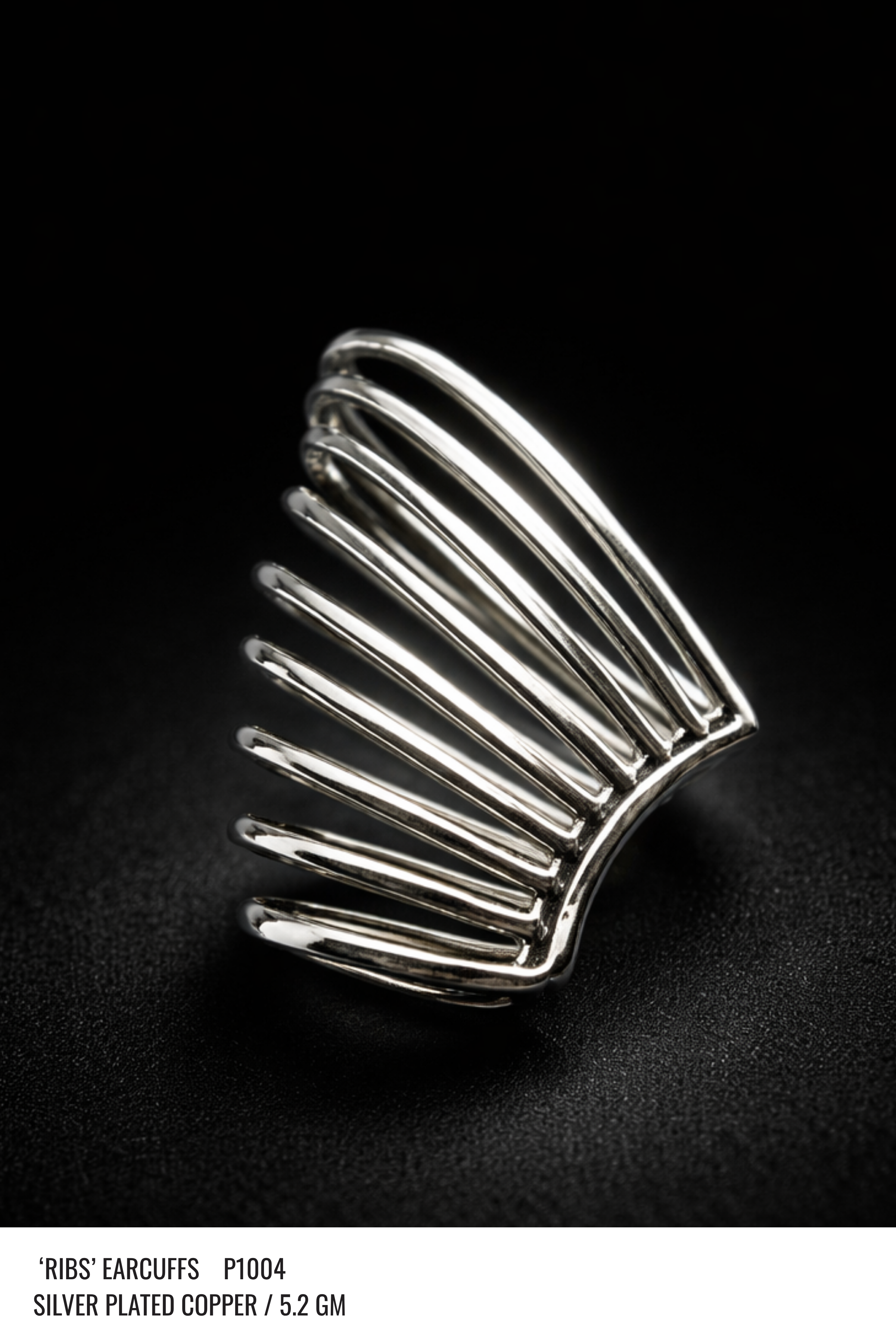A matching pair of silver ear cuffs shown together on a plain background