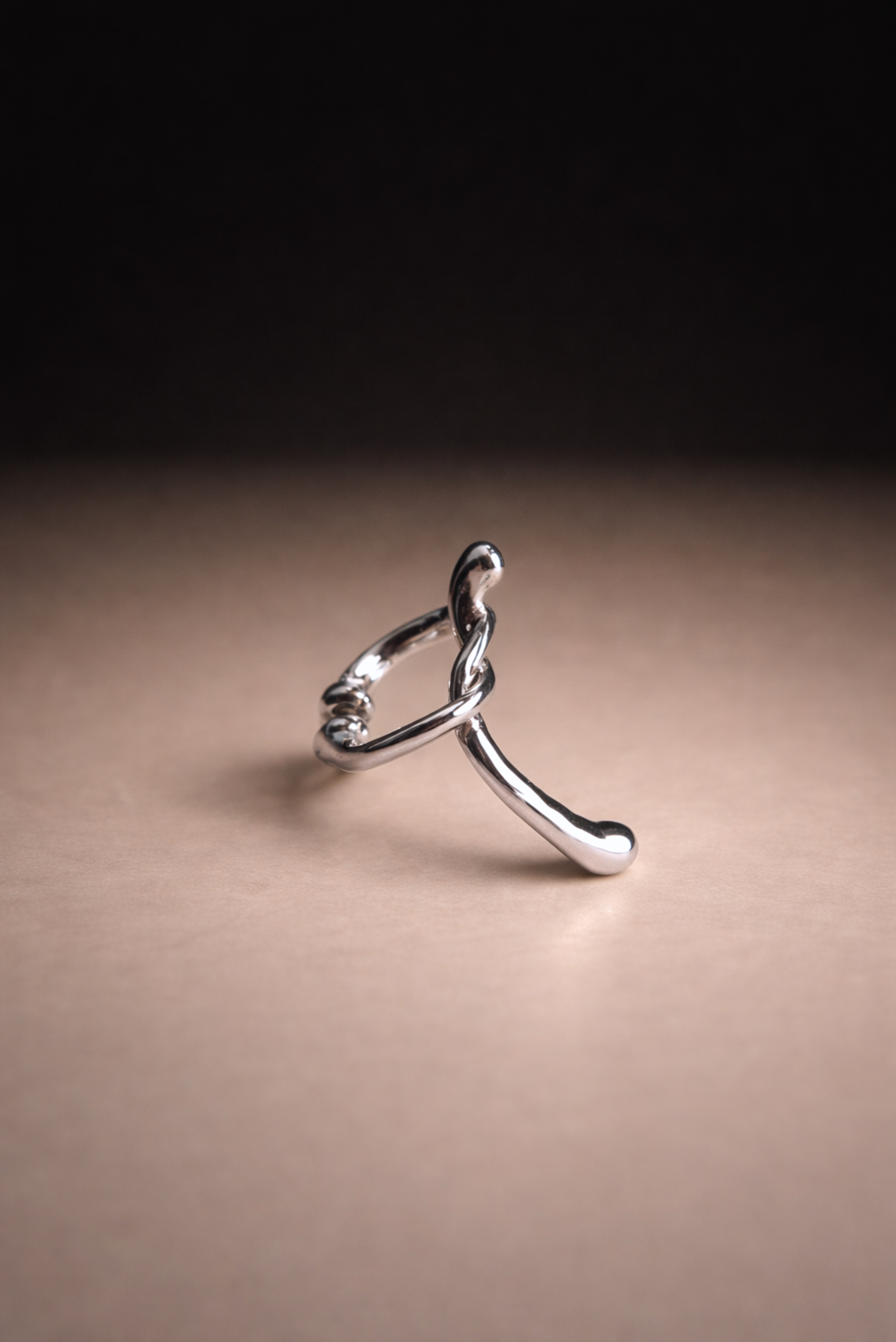 A bold geometric silver ear cuff shown on its own