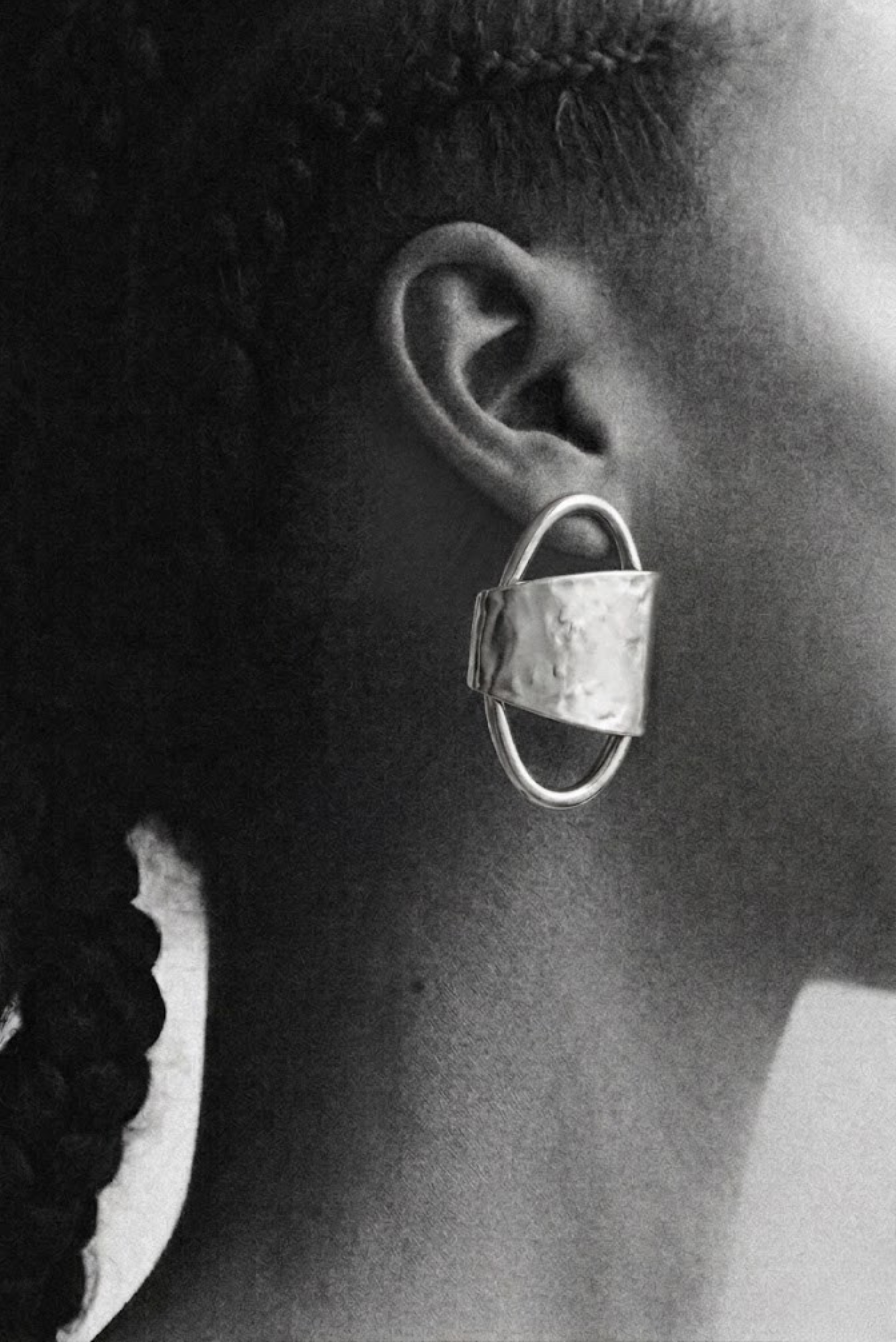 A model wearing oversized gold statement stud earrings