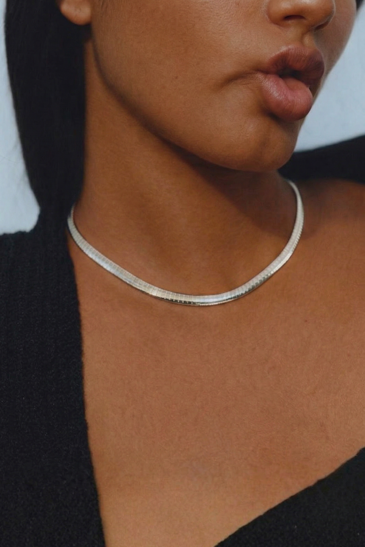 A minimal silver necklace styled for everyday wear