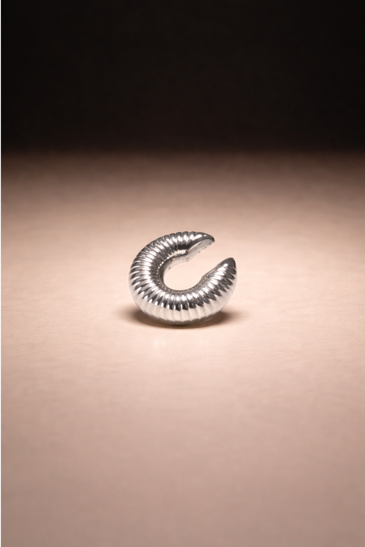An oversized ear cuff styled as a single statement piece