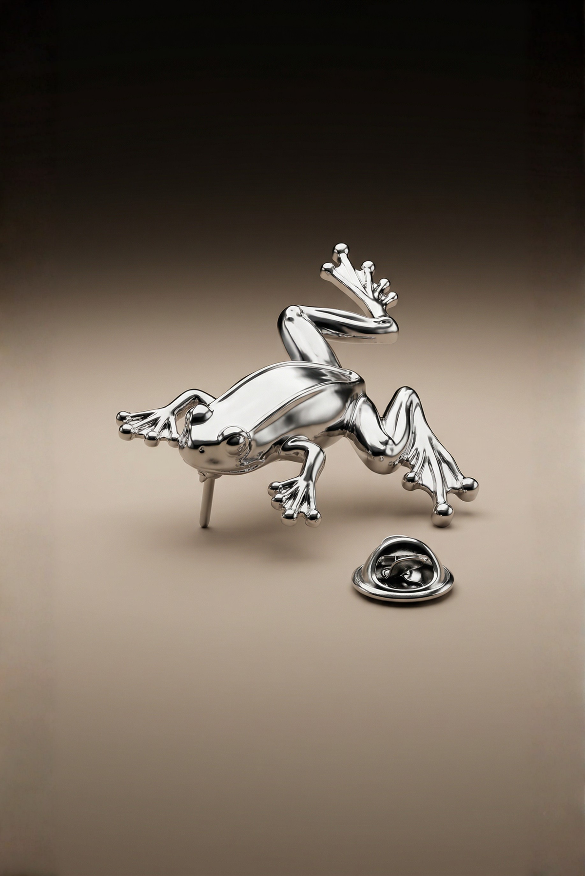 A silver frog-shaped pin fastened to a lapel