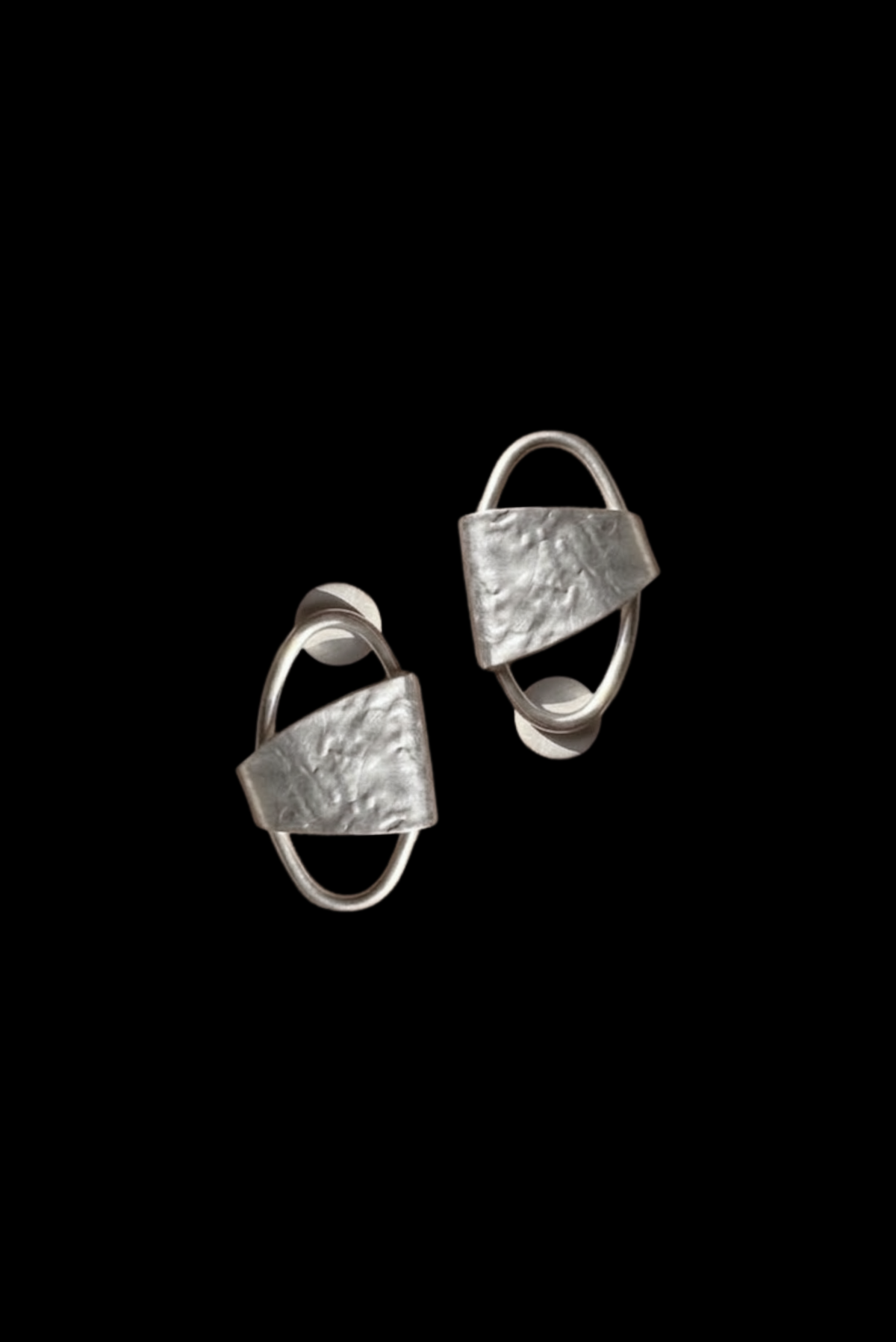 Oversized gold geometric studs styled as a statement pair