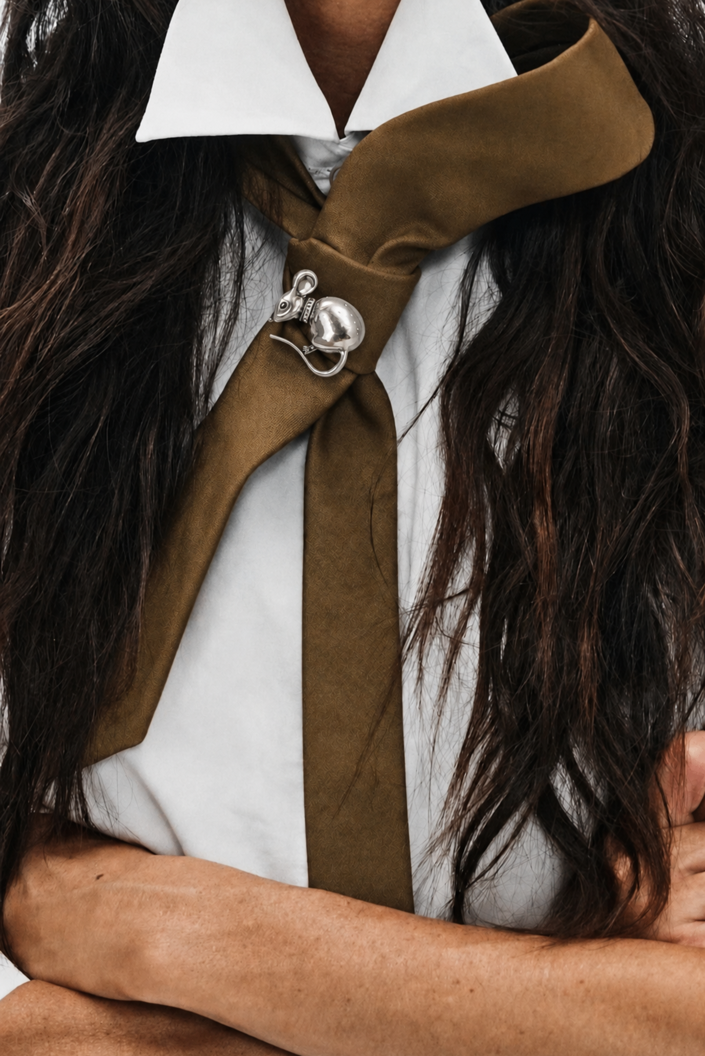 A mouse-shaped pin brooch fastened to a lapel
