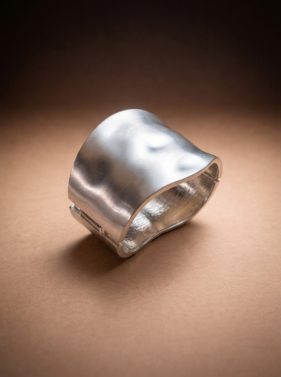 A silver cuff bracelet shown on its own against a plain background